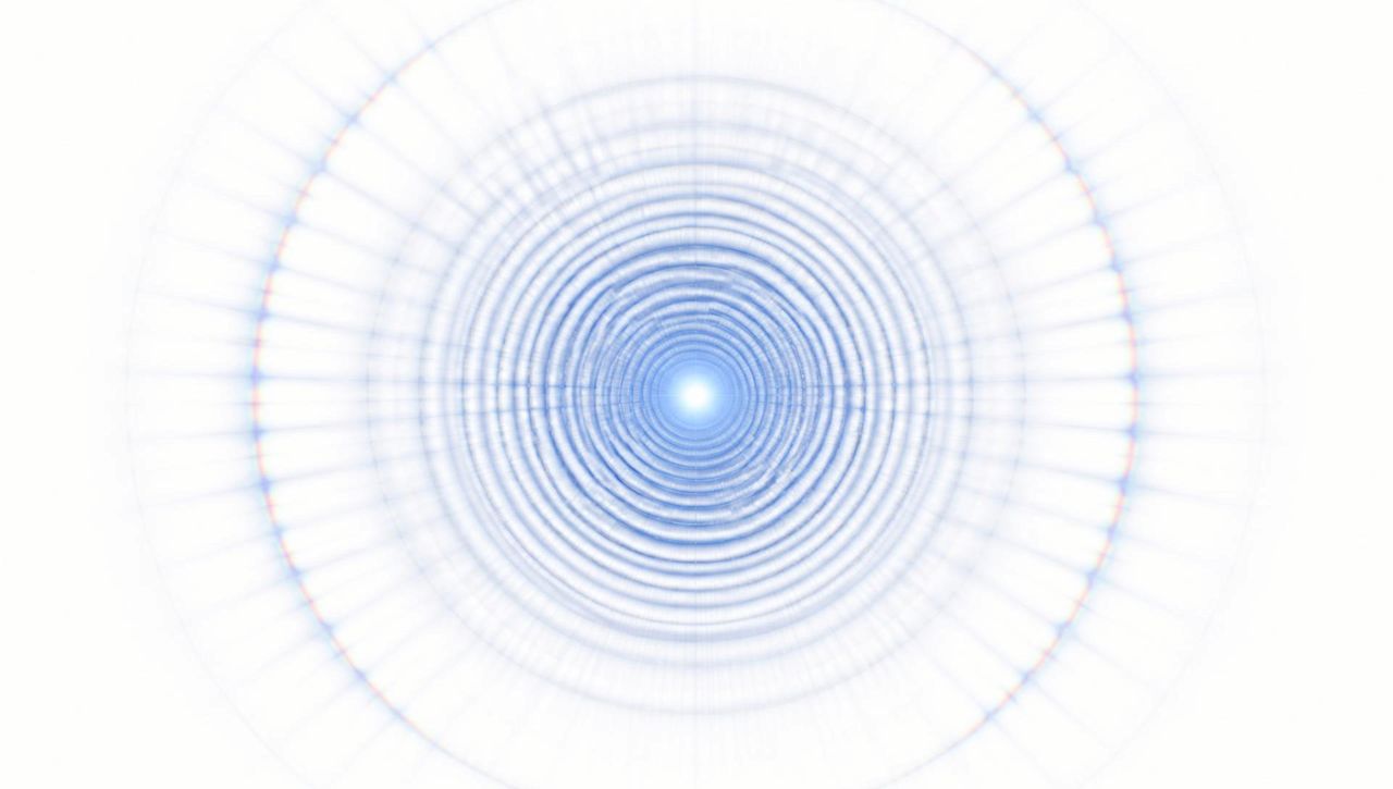 Hundreds of hairline cobalt diffraction rings receding to a single point of white light — an Airy pattern aperture